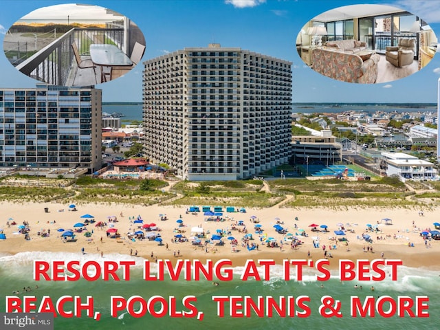 view of building exterior featuring a beach view and a water view