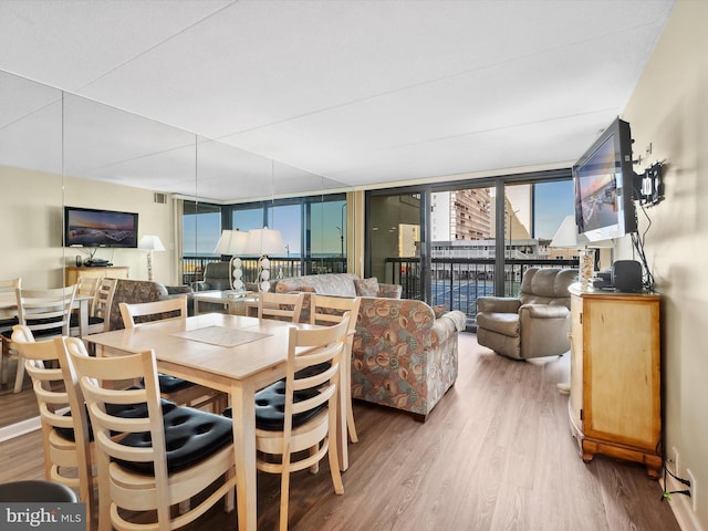 dining room featuring hardwood / wood-style flooring and floor to ceiling windows