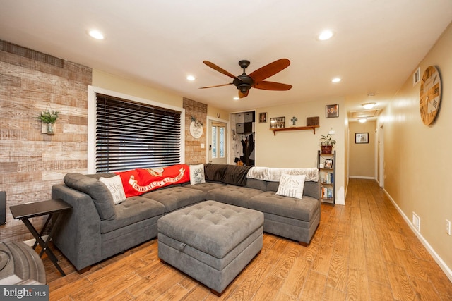 living room featuring ceiling fan and light wood-type flooring