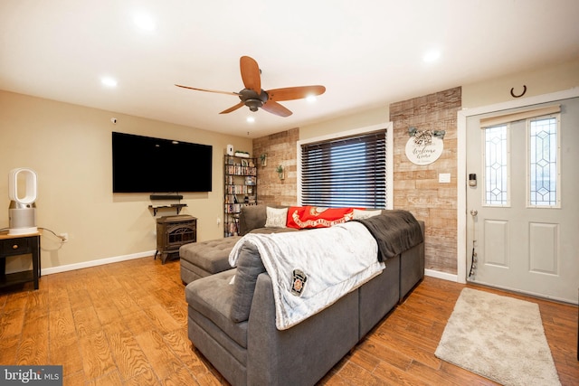 living room with wood-type flooring and ceiling fan