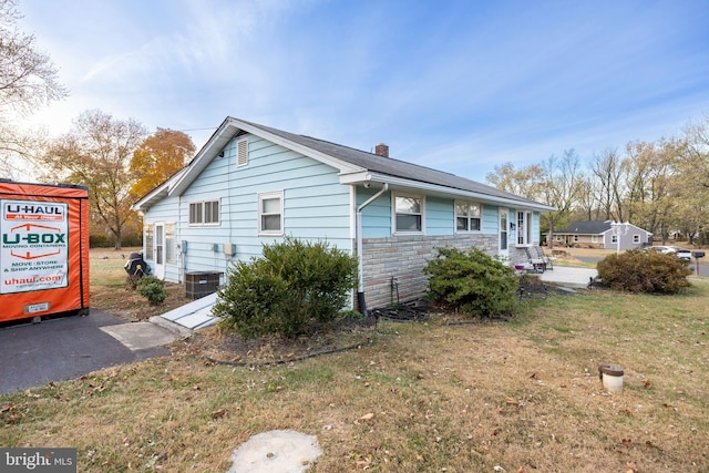 view of side of home featuring a yard