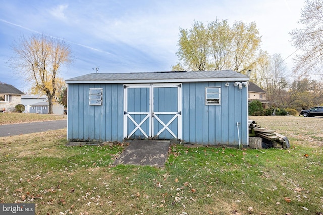 view of outbuilding featuring a yard