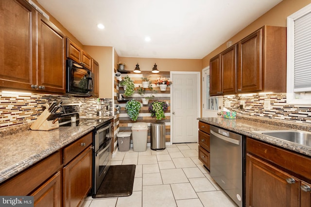 kitchen with appliances with stainless steel finishes, decorative backsplash, and light tile patterned floors