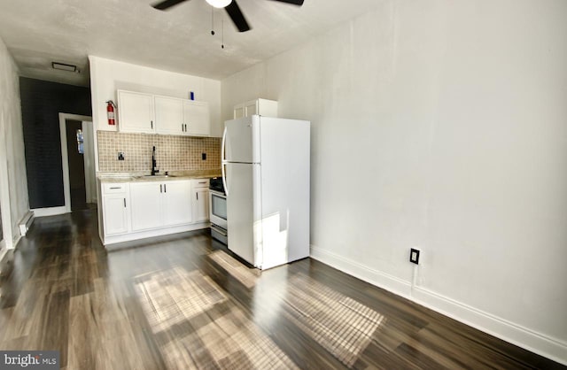 kitchen featuring dark hardwood / wood-style flooring, white cabinetry, sink, and white refrigerator