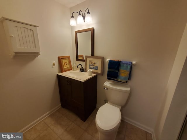 bathroom featuring toilet and vanity