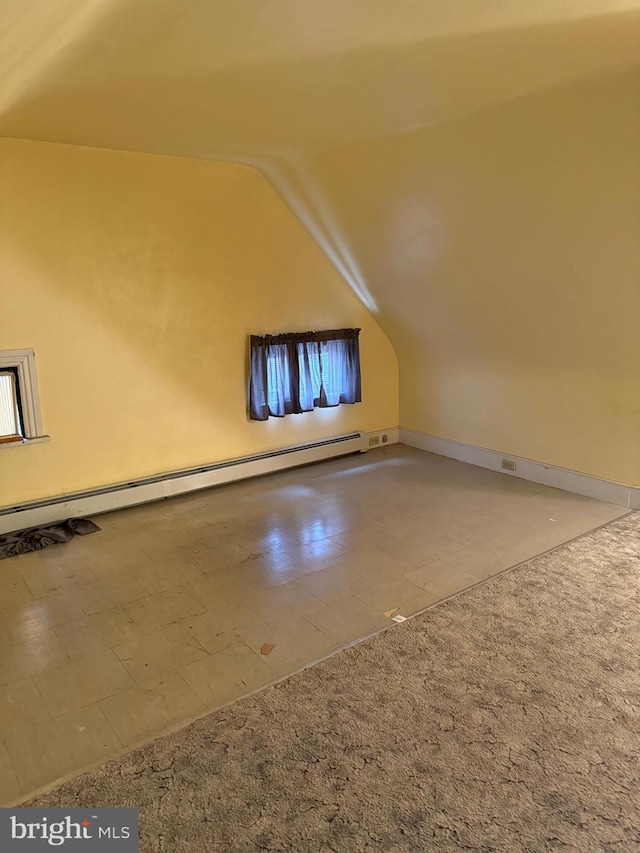 bonus room featuring carpet, vaulted ceiling, and a baseboard heating unit