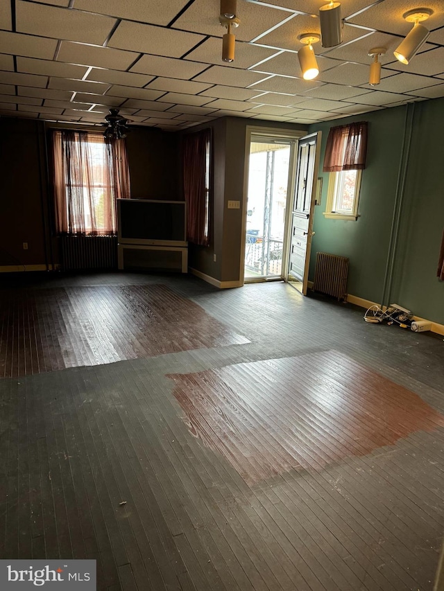 spare room featuring hardwood / wood-style floors and radiator