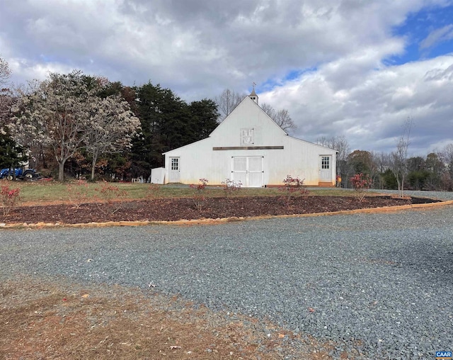 view of side of home with an outbuilding