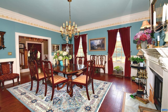 dining space featuring ornamental molding, dark wood-type flooring, and a chandelier