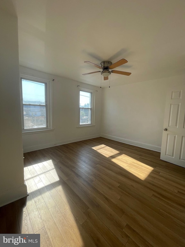 unfurnished room featuring ceiling fan and hardwood / wood-style floors