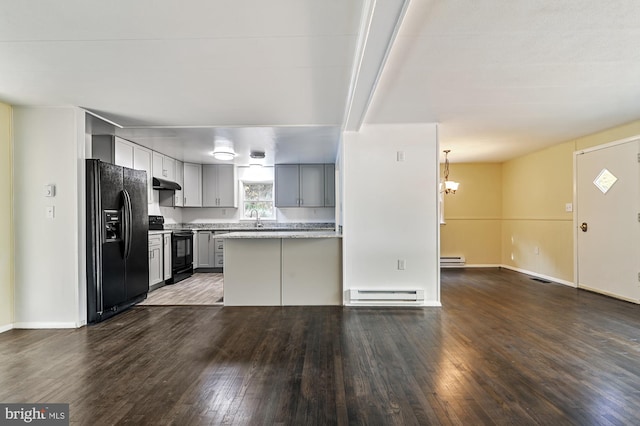 kitchen with dark wood-type flooring, black appliances, gray cabinetry, baseboard heating, and decorative light fixtures