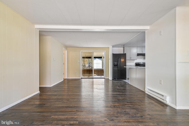 unfurnished living room featuring dark hardwood / wood-style flooring, wood walls, beam ceiling, and a baseboard radiator