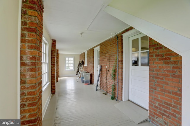 43086 Lucketts Rd, Leesburg, VA 20176 - hallway featuring wood finished floors and brick wall