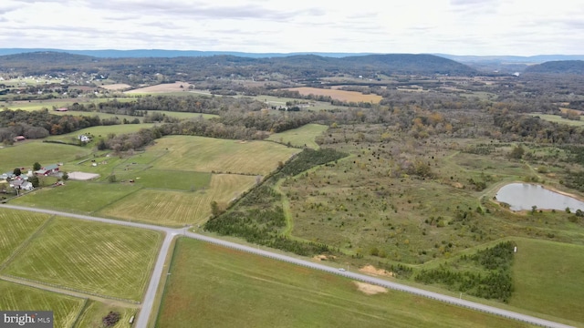 aerial view with a water and mountain view and a rural view