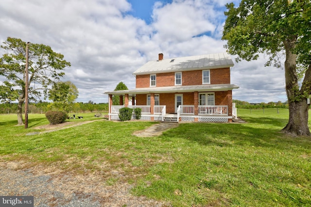 43086 Lucketts Rd, Leesburg, VA 20176 - back of property with a chimney, a yard, brick siding, and covered porch