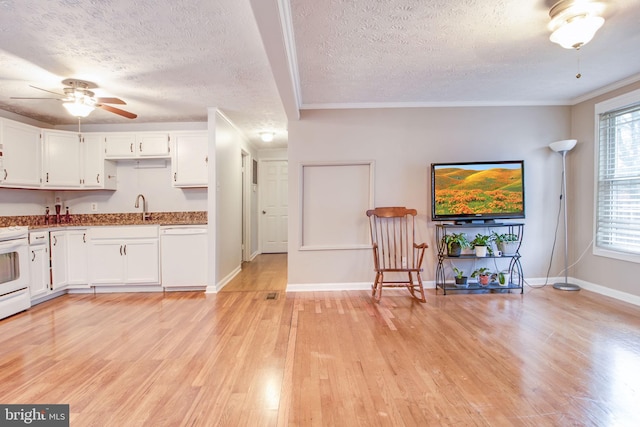 kitchen featuring white cabinets, light hardwood / wood-style floors, white appliances, and crown molding