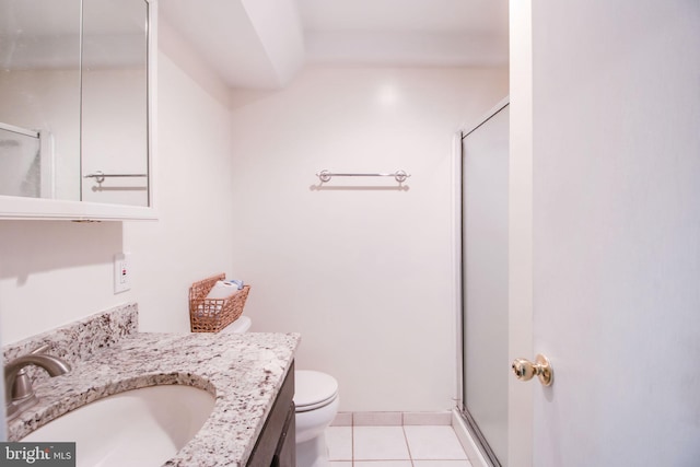 bathroom with tile patterned flooring, vanity, toilet, and walk in shower