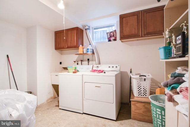 laundry room with cabinets and washer and dryer