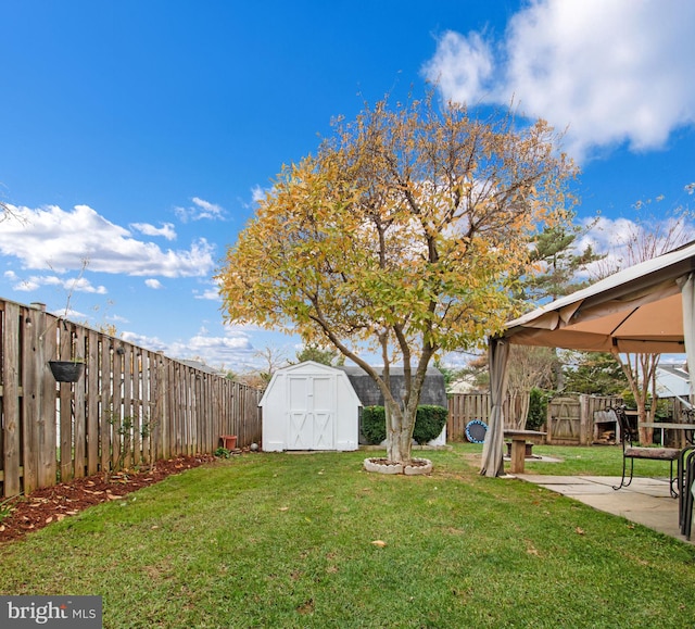 view of yard featuring a gazebo, a patio, and a storage unit