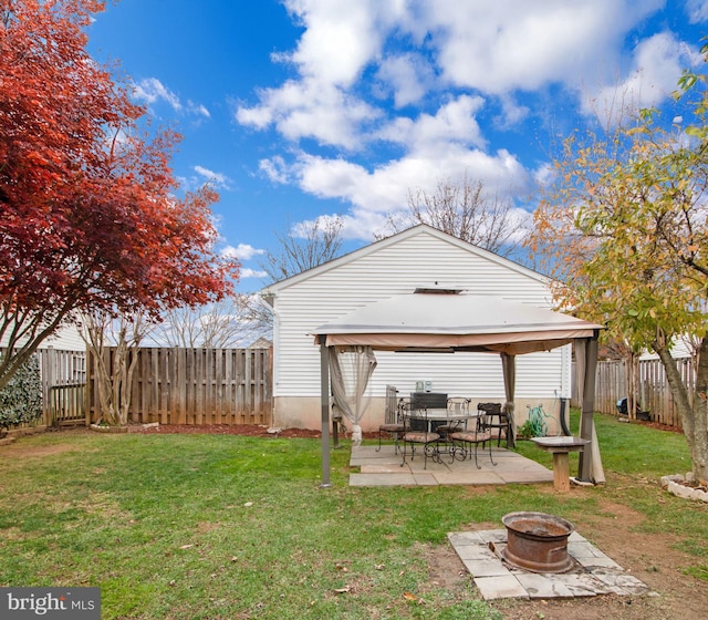 exterior space featuring a gazebo, a patio, and a fire pit