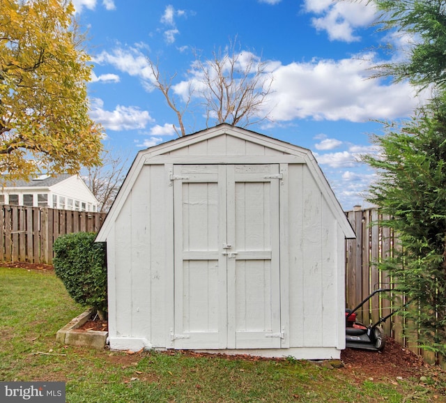 view of outbuilding featuring a lawn