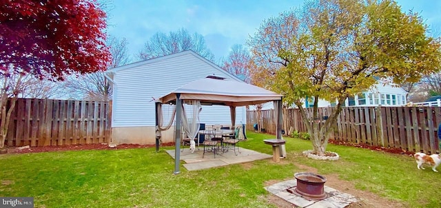 view of yard with a gazebo, a patio, and an outdoor fire pit