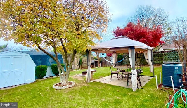 view of yard featuring a gazebo, a patio, central AC, and a storage shed