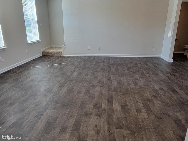 spare room with dark hardwood / wood-style floors