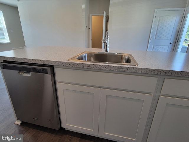 kitchen featuring stainless steel dishwasher, sink, dark hardwood / wood-style floors, and a wealth of natural light