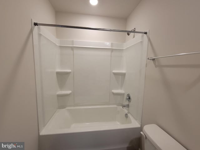 bathroom with shower / washtub combination and toilet