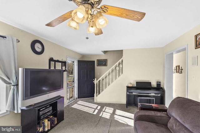 carpeted living room with ceiling fan