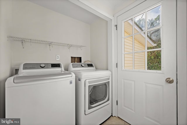 clothes washing area with washing machine and dryer