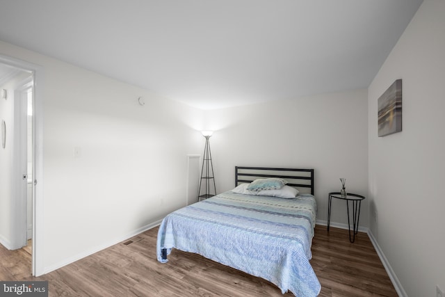 bedroom with hardwood / wood-style floors