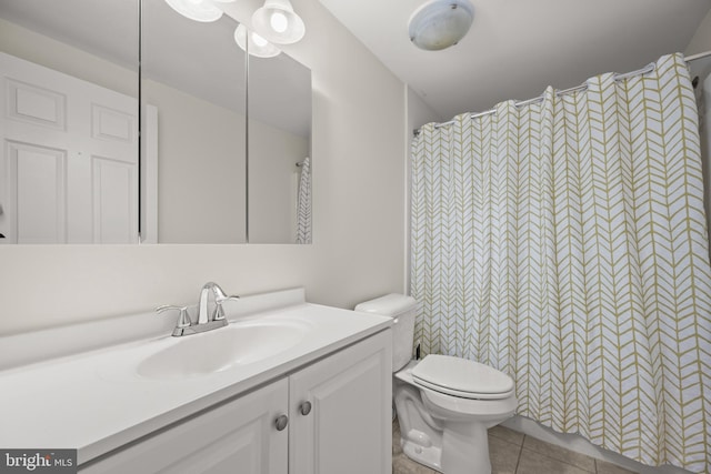 bathroom with a shower with curtain, tile patterned flooring, vanity, and toilet