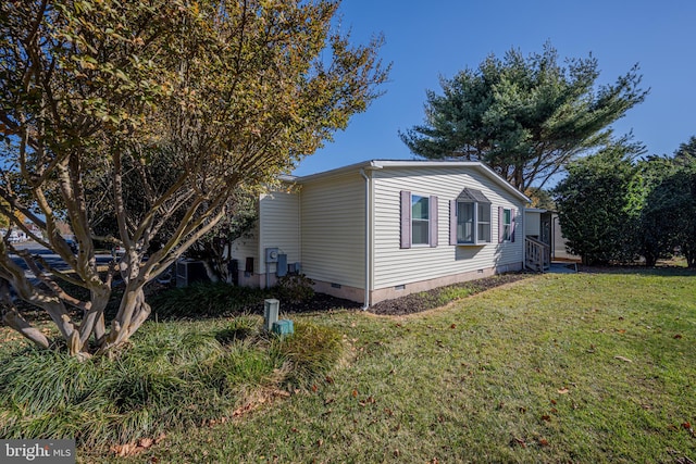 view of side of home featuring a lawn