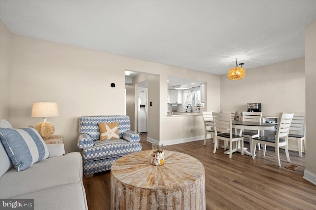 living room with sink and dark hardwood / wood-style flooring