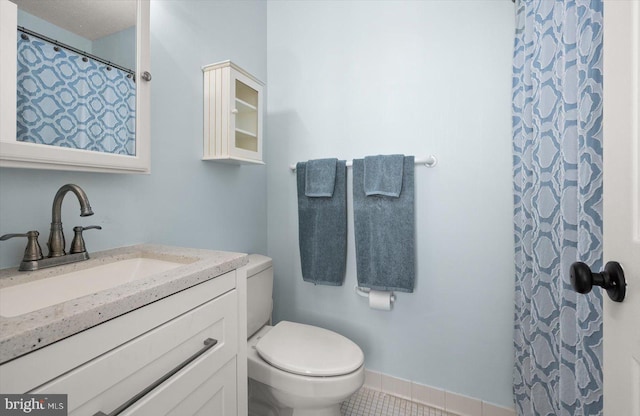 bathroom featuring vanity, toilet, curtained shower, and tile patterned flooring