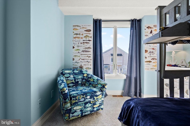 bedroom featuring a textured ceiling and carpet flooring