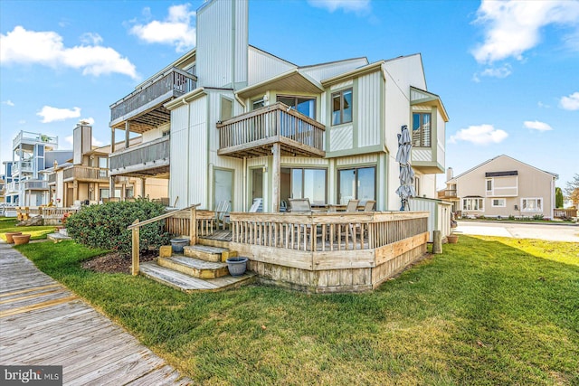 back of property featuring a lawn and a balcony