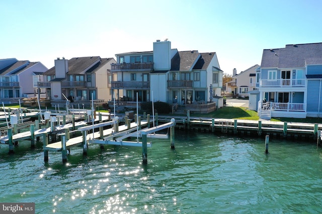 view of dock featuring a balcony and a water view