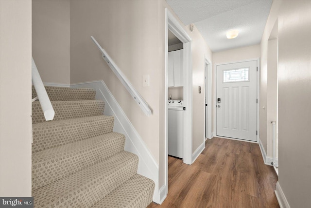 foyer featuring a textured ceiling and hardwood / wood-style flooring