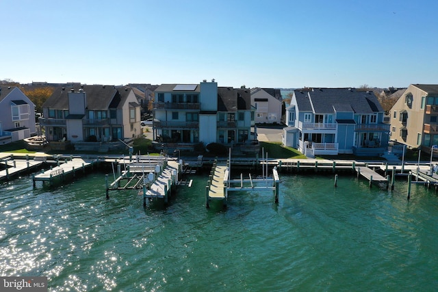 dock area featuring a water view and a balcony