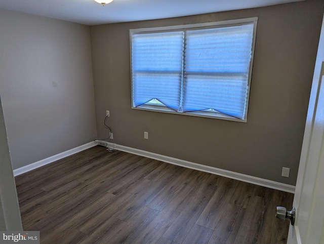 empty room featuring dark wood-type flooring