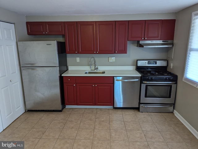 kitchen featuring stainless steel appliances, sink, and light tile patterned floors