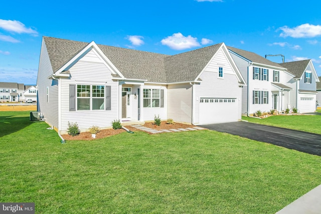 view of front of property with a front lawn, central AC, and a garage