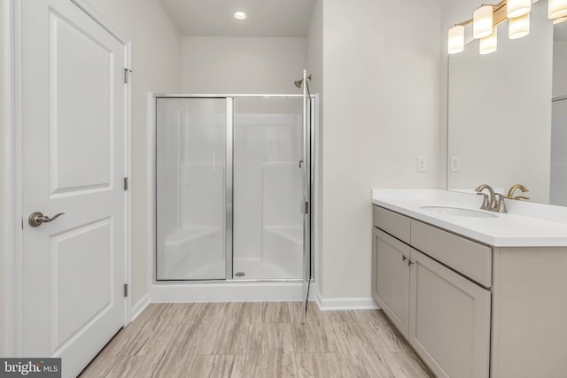 bathroom featuring vanity, hardwood / wood-style floors, and an enclosed shower