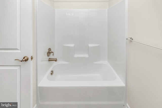 bathroom with bathing tub / shower combination