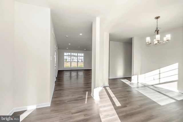 interior space with dark wood-type flooring and a notable chandelier