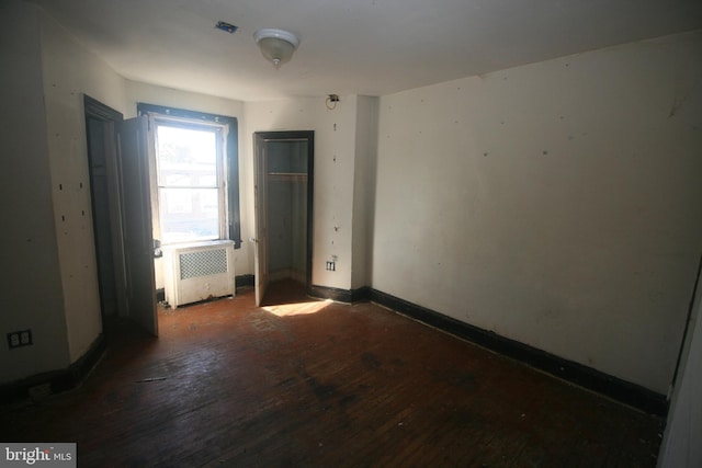 6659 N 20th St, Philadelphia, PA 19138 - unfurnished bedroom featuring a closet, baseboards, wood-type flooring, and radiator heating unit