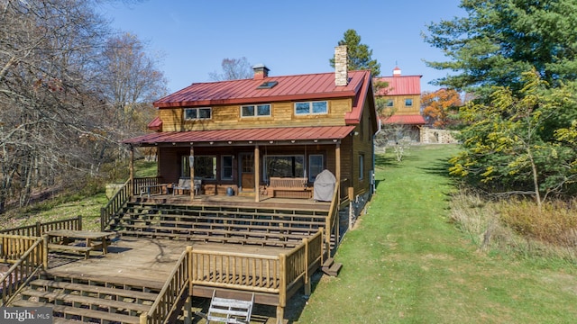 rear view of property with a lawn